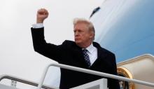 U.S. President Donald Trump pumps his fist as he boards Air Force One upon departure from Joint Base Andrews in Maryland, U.S., January 12, 2018. PHOTO BY REUTERS/Kevin Lamarque