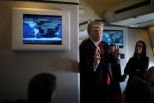 U.S. President Donald Trump talks to journalists members of the travel pool on board the Air Force One during his trip to Palm Beach, Florida while flying over South Carolina, U.S., February 3, 2017. PHOTO BY REUTERS/Carlos Barria