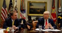 Director of the Office of Management and Budget Mick Mulvaney (L) listens to U.S. President Donald Trump speak during a "strategic initiatives" lunch at the White House in Washington, U.S., February 22, 2017. PHOTO BY REUTERS/Kevin Lamarque