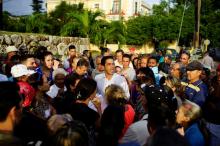A Colombian Embassy employee (C) speaks to people waiting for their turn to enter the Embassy in Havana, Cuba, January 12, 2018. PHOTO BY REUTERS/Alexandre Meneghini