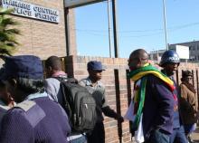 Zimbabwean Pastor Evan Mawarire (2nd R), who organized a 'stay at home' anti-government protest last week, arrives at the Harare Central Police station in Zimbabwe, July 12, 2016. PHOTO BY REUTERS/Philimon Bulawayo
