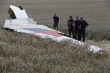Members of a group of international experts inspect wreckage at the site where the downed Malaysia Airlines flight MH17 crashed, near the village of Hrabove (Grabovo) in Donetsk region, eastern Ukraine