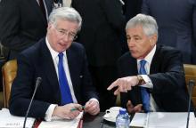 Britain's Defence Secretary Michael Fallon listens to U.S. Secretary of Defense Chuck Hagel (R) during a NATO defence ministers meeting at the Alliance headquarters in Brussels, February 5, 2015. PHOTO BY REUTERS/Francois Lenoir