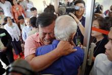 Soum Rithy (C), who lost his father and three siblings during the Khmer Rouge regime, breaks out in tears and hugs another survivor after the verdict was delivered in the trial of former Khmer Rouge head of state Khieu Samphan and former Khmer Rouge leader ''Brother Number Two'' Nuon Chea at the Extraordinary Chambers in the Courts of Cambodia (ECCC) on the outskirts Phnom Penh