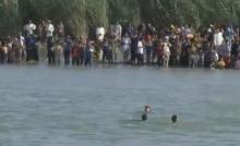 A still image from video released June 6, 2016 shows Iraqi families attempting to escape the besieged city of Falluja, Iraq, by crossing the Euphrates river, June 3, 2016. PHOTO BY REUTERS
