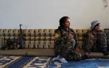 Female Kurdish fighters from the People's Protection Units (YPG) sit in a house in Raqqa, Syria, June 15, 2017. PHOTO BY REUTERS/Goran Tomasevic