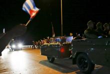 The caravan carrying the ashes of Fidel Castro passes along a street on the way to the eastern city of Santiago, in Ranchuelo, Cuba, November 30, 2016. PHOTO BY REUTERS/Carlos Barria