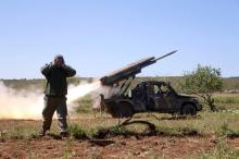 A rebel fighter from the Ahrar al-Sham Islamic Movement reacts as they fire grad rockets from Idlib countryside, towards forces loyal to Syria's President Bashar al-Assad stationed at Jureen town in al-Ghab plain in the Hama countryside, Syria, April 25, 2015. PHOTO BY REUTERS/Mohamad Bayoush