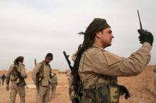 A Syrian Democratic Forces (SDF) fighter carries a walkie talkie as he stands with his fellow fighters during an offensive against Islamic State militants in northern Raqqa province, Syria, February 8, 2017. PHOTO BY REUTERS/Rodi Said