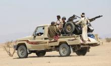 Tribal fighters loyal to Yemen's government ride on the back of a pick-up truck to their position during fighting against Houthi rebels in an area between Yemen's northern provoices of al-Jawf and Marib, December 5, 2015. PHOTO BY REUTERS/Ali Owidha