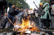 People burn placards and effigies of India's main opposition Congress party's leaders Sajjan Kumar and Kamal Nath during a protest near Congress party's headquarters in New Delhi, India, December 17, 2018. PHOTO BY REUTERS/Anushree Fadnavis
