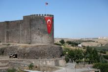 A Turkish flag hangs on the historical city walls at one of the entrance of Sur district in Diyarbakir, Turkey, July 11, 2016. PHOTO BY REUTERS/Sertac Kayar