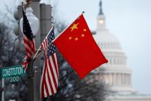 The People's Republic of China flag and the U.S. Stars and Stripes fly on a lamp post along Pennsylvania Avenue near the U.S. Capitol during Chinese President Hu Jintao's state visit, in Washington, D.C.,U.S., January 18, 2011. PHOTO BY REUTERS/Hyungwon Kang