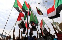 People wave national flags as they demonstrate against the killing of protesting children, who were shot dead when security forces broke up a student protest in Khartoum, Sudan, August 1, 2019. PHOTO BY REUTERS/Mohamed Nureldin Abdallah