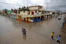 People walk in a flooded area after Hurricane Matthew in Les Cayes, Haiti, October 5, 2016. PHOTO BY REUTERS/Andres Martinez Casares