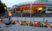 A woman lays flowers in front of the Olympia shopping mall, where yesterday's shooting rampage started, in Munich, Germany, July 23, 2016. PHOTO BY REUTERS/Arnd Wiegmann