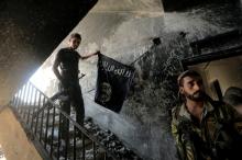A member of the Syrian Democratic Forces calls his comrades during the fighting with Islamic State fighters in Raqqa, Syria, August 14, 2017. PHOTO BY REUTERS/Zohra Bensemra