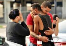 Friends and family members embrace outside the Orlando Police Headquarters during the investigation of a shooting at the Pulse night club in Orlando, Florida, U.S., June 12, 2016. PHOTO BY REUTERS/Steve Nesius