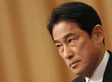 Japan's Foreign Minister Fumio Kishida listens to questions from a participant during a seminar in Tokyo