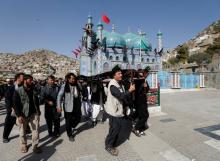 Afghan Shi'ite Muslims carry a coffin of one of the victims of Tuesday's attack at the Sakhi Shrine in Kabul, Afghanistan, October 12, 2016. PHOTO BY REUTERS/Mohammad Ismail