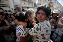 Friends and family react during the funeral of Madelin Patricia Hernandez, a victim of a fire at the Virgen de Asuncion children shelter, at the cemetery in Guatemala City, Guatemala, March 10, 2017. PHOTO BY REUTERS/Saul Martinez