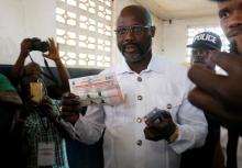 George Weah, former soccer player and presidential candidate of Congress for Democratic Change (CDC), prepares his ballot during presidential elections at a polling station in Monrovia, Liberia, December 26, 2017. PHOTO BY REUTERS/Thierry Gouegnon 