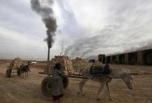 A girl works in a brick factory in the town of Nahrawan, east of Baghdad, March 8, 2012. PHOTO BY REUTERS/Thaier al-Sudani