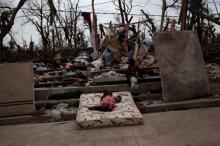 Two girls play amid the rubble after Hurricane Matthew in a street of Port-a-Piment, Haiti, October 9, 2016. PHOTO BY REUTERS/Andres Martinez Casares