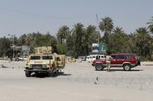 Iraqi security forces stand guard near the site of a suicide attack, which was targeting a checkpoint, in Baghdad April 4, 2016. PHOTO BY REUTERS/Ahmed Saad