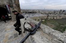 A Syrian army soldier sits near his weapon at Aleppo's historic citadel, in the Old City of Aleppo, Syria, January 31, 2017. PHOTO BY REUTERS/Omar Sanadiki