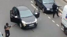 Gunmen flee the offices of French satirical newspaper Charlie Hebdo in Paris, in this still image taken from amateur video shot on January 7, 2015, and obtained by Reuters. PHOTO BY REUTERS/Handout via Reuters TV