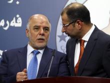 Salim al-Jabouri (R), new Prime Minister Haider Abadi (L), a member of Iraqi Prime Minister Nuri al-Maliki's State of Law bloc, speak during a news conference in Baghdad