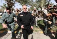 Iraq's Prime Minister Haider al-Abadi (front 2nd L) walks during his visit to an Iraqi army base in Camp Tariq near Falluja, Iraq, June 1, 2016. PHOTO BY REUTERS/Alaa Al-Marjani