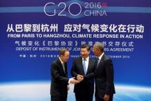 Chinese President Xi Jinping (C), UN Secretary General Ban Ki-moon and U.S. President Barack Obama (R) shake hands during a joint ratification of the Paris climate change agreement ceremony ahead of the G20 Summit at the West Lake State Guest House in Hangzhou, China, September 3, 2016. PHOTO BY REUTERS/How Hwee Young