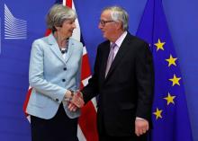 Britain's Prime Minister Theresa May is welcomed by European Commission President Jean-Claude Juncker at the EC headquarters in Brussels, Belgium, December 8, 2017. PHOTO BY REUTERS/Yves Herman