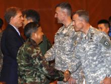 Thailand's Deputy Supreme Commander, General Wuttinun Leelayudth (2nd L) and Patrick Murphy (L), U.S. Charge-d'affaires in Thailand shakes hand with U.S. soldiers during the opening ceremony for Cobra Gold at a military academy in Nakhon Nayok province, east of Bangkok, February 9, 2015. PHOTO BY REUTERS/Chaiwat Subprasom