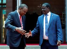Kenya's President Uhuru Kenyatta (L) greets opposition leader Raila Odinga of the National Super Alliance (NASA) coalition after addressing a news conference at the Harambee house office in Nairobi, Kenya, March 9, 2018. PHOTO BY REUTERS/Thomas Mukoya