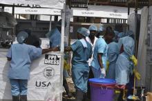 Health workers enter an Ebola treatment center in Monrovia, Liberia, December 16, 2014. PHOTO BY REUTERS/James Giahyue