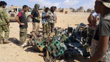 Libyans gather around the remains of a helicopter that crashed near Benghazi, Libya, July 20, 2016. PHOTO BY REUTERS/Stringer
