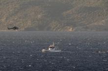 A Greek Coast Guard helicopter flies over a Frontex vessel trying to rescue refugees and migrants, after a boat carrying more than 200 people sunk while crossing part of the Aegean sea from Turkey, near the Greek island of Lesbos, October 28, 2015. PHOTO BY REUTERS/Giorgos Moutafis