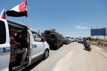 Russian military vehicles are seen in a convoy during the re-opening of the road between Homs and Hama in Rastan, Syria, June 6, 2018. PHOTO BY REUTERS/Omar Sanadiki