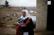 Ayman, a boy from a minority Yazidi community, who was sold by Islamic State militants to a Muslim couple in Mosul, hugs his grandmother after he was returned to his Yazidi family, in Duhok, Iraq, January 31, 2017. PHOTO BY REUTERS/Muhammad Hamed
