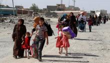 Residents who fled their homes due to fighting between Iraqi forces and Islamic State militants return to their village cleared by the Iraqi forces in western Mosul in Iraq, June 7, 2017. PHOTO BY REUTERS/Erik De Castro