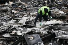 A Dutch investigator works at the site where the downed Malaysia Airlines flight MH17 crashed, near the village of Hrabove (Grabovo) in Donetsk region, eastern Ukraine, November 16, 2014. PHOTO BY REUTERS/Maxim Zmeyev