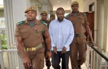 Ugandan rebel leader Jamil Mukulu (C) is escorted by Tanzanian prison wardens to the Kisutu resident's magistrate court in Dar es Salaam, May 22, 2015. PHOTO BY REUTERS/Stringer
