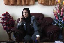 Colonel Jamila Bayaaz talks on the phone at her office before an interview in Kabul