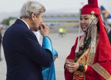U.S. Secretary of State John Kerry samples cheese curds presented by a woman in traditional attire (R) upon his arrival at Chinggis Khaan International Airport in Ulaanbaatar, Mongolia, June 5, 2016. PHOTO BY REUTERS/Saul Loeb