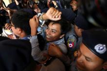 Reuters journalists Kyaw Soe Oo (C) and Wa Lone (L) appear in court in Yangon, Myanmar, January 10, 2018. PHOTO BY REUTERS/Stringer