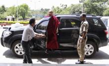 Karmapa Lama (C) alights from a car before his departure to Mumbai, at the airport on the outskirts of the northern Indian hilltown of Dharmsala, May 12, 2011. PHOTO BY REUTERS/Shailesh Bhatnagar
