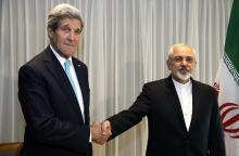 U.S. Secretary of State John Kerry shakes hands with Iranian Foreign Minister Mohammad Javad Zarif before a meeting in Geneva, January 14, 2015. PHOTO BY REUTERS/Rick Wilking
